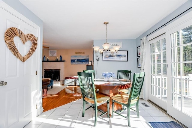 tiled dining room with a chandelier