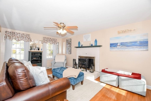 living room with hardwood / wood-style flooring, a fireplace, and ceiling fan