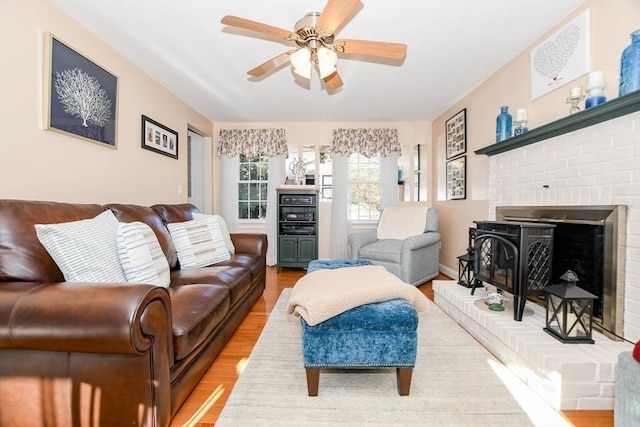 living room with hardwood / wood-style flooring and ceiling fan