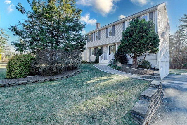 colonial-style house with a front yard