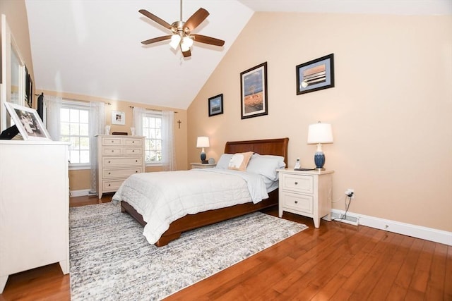 bedroom with ceiling fan, wood-type flooring, and high vaulted ceiling