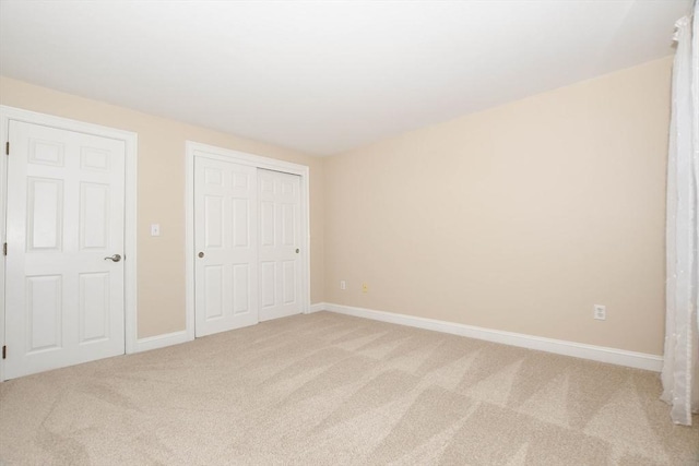 unfurnished bedroom with carpet floors and a closet