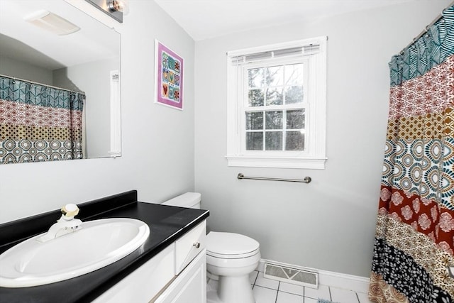 bathroom with tile patterned flooring, vanity, and toilet