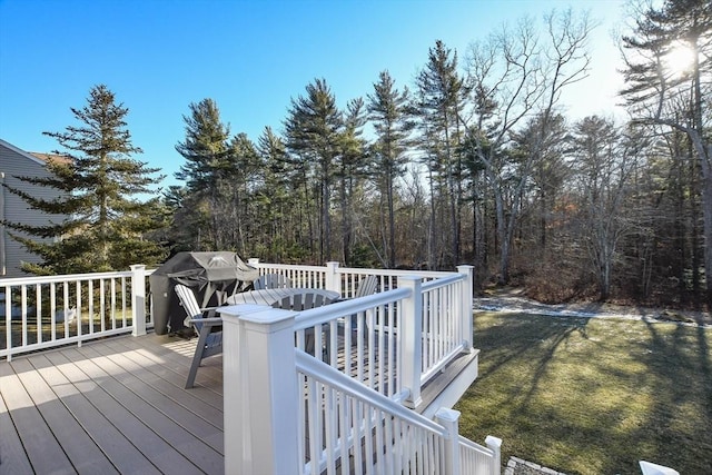 wooden terrace featuring a lawn