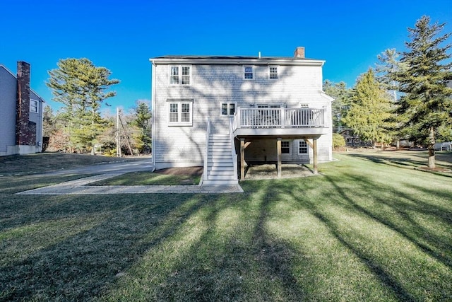 back of property featuring a yard and a deck