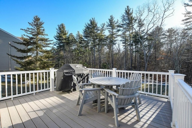 wooden terrace with a grill