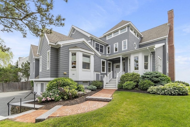 30 Preston Ct Unit 1, Swampscott, MA 01907 - view of front facade with a garage, a chimney, a shingled roof, and concrete driveway