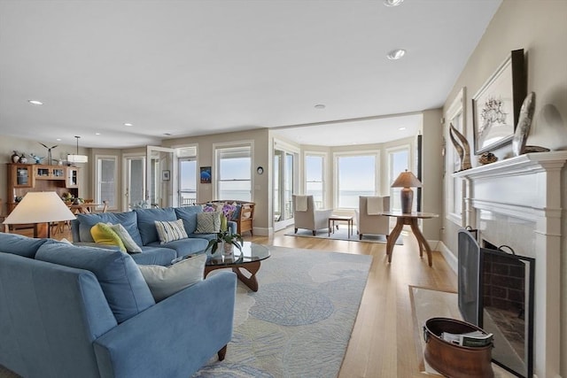 30 Preston Ct Unit 1, Swampscott, MA 01907 - living room with light wood finished floors, a fireplace with flush hearth, and recessed lighting