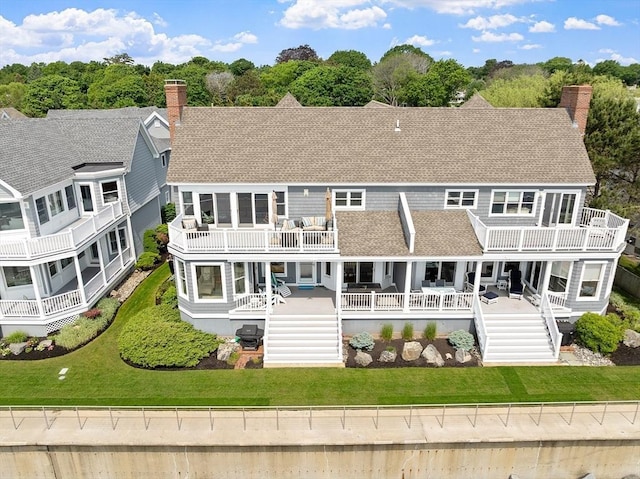 30 Preston Ct Unit 1, Swampscott, MA 01907 - back of property featuring a balcony, roof with shingles, stairs, and a chimney
