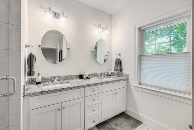 41 Old Main Rd Unit 3A, Falmouth, MA 02556 - bathroom featuring double vanity, a tile shower, and baseboards