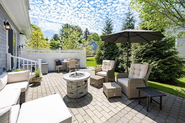 41 Old Main Rd Unit 3A, Falmouth, MA 02556 - view of patio featuring an outdoor living space with a fire pit and fence