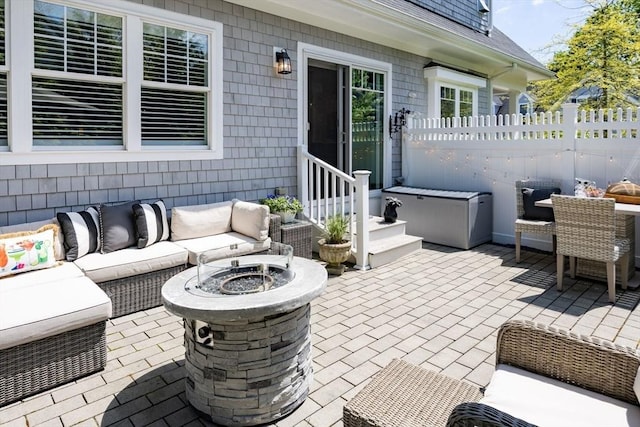 41 Old Main Rd Unit 3A, Falmouth, MA 02556 - view of patio with an outdoor living space with a fire pit, fence, and outdoor dining area