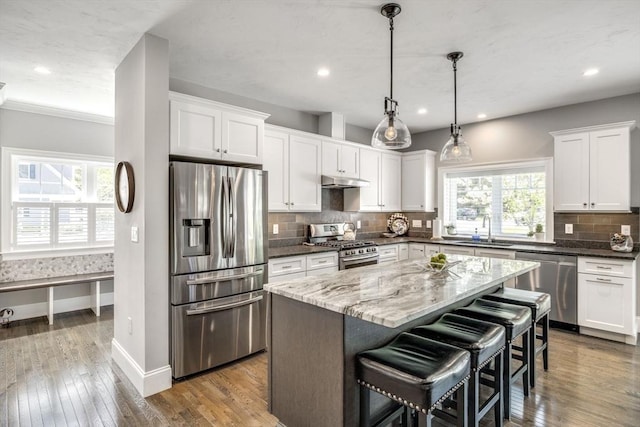 41 Old Main Rd Unit 3A, Falmouth, MA 02556 - kitchen featuring stainless steel appliances, a sink, white cabinetry, under cabinet range hood, and recessed lighting