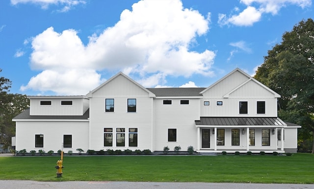 modern farmhouse style home featuring a front yard and covered porch