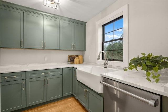 13 Alden Rd, Andover, MA 01810 - kitchen featuring stainless steel dishwasher, a sink, green cabinetry, light wood-style floors, and light stone counters