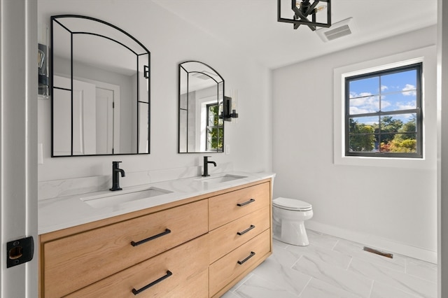 bathroom featuring vanity and toilet