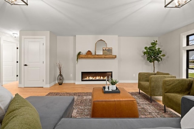 13 Alden Rd, Andover, MA 01810 - living area with baseboards, wood finished floors, a chandelier, and a lit fireplace