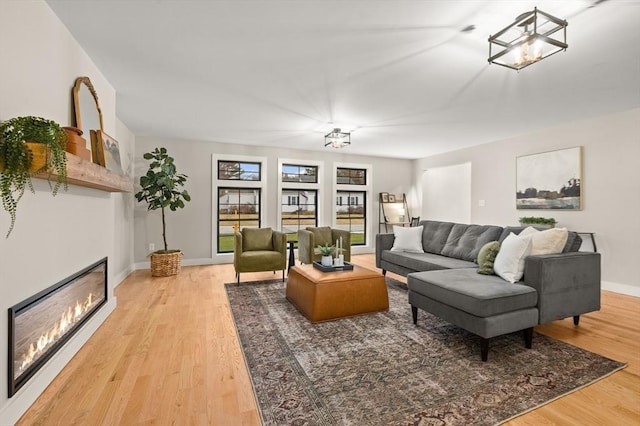 13 Alden Rd, Andover, MA 01810 - living room featuring light wood-type flooring, baseboards, and a glass covered fireplace