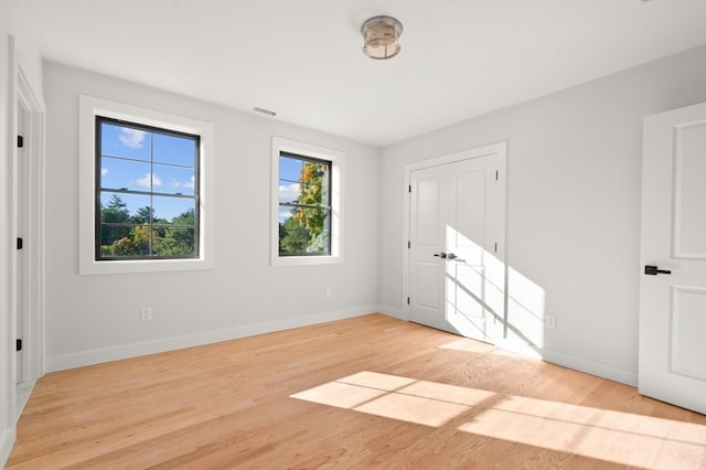 unfurnished bedroom with light wood-type flooring