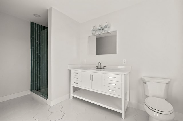 bathroom featuring vanity, tile patterned floors, toilet, and tiled shower