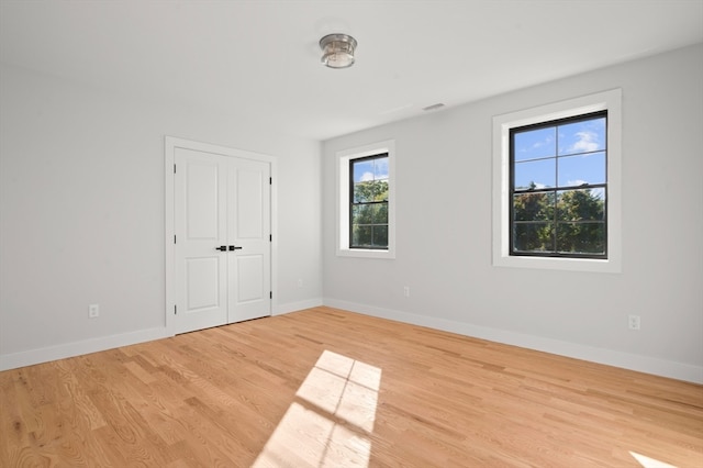 unfurnished room with light hardwood / wood-style flooring