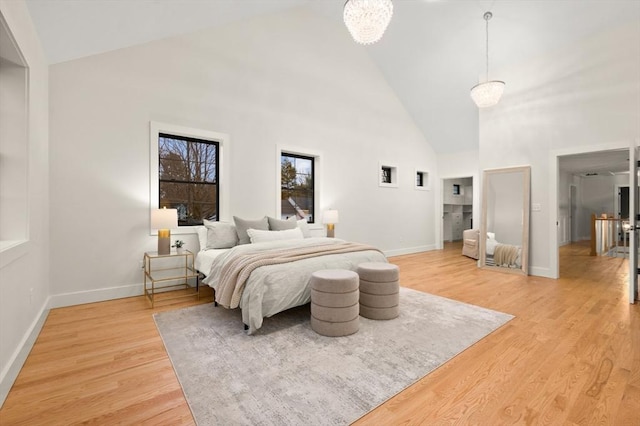 13 Alden Rd, Andover, MA 01810 - bedroom with high vaulted ceiling, baseboards, a chandelier, and light wood-type flooring