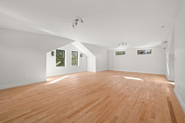 additional living space with light hardwood / wood-style flooring