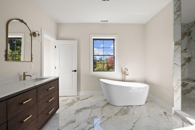 13 Alden Rd, Andover, MA 01810 - bathroom featuring marble finish floor, a freestanding bath, vanity, baseboards, and walk in shower