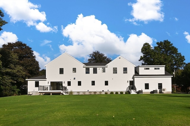 back of house featuring a yard and a wooden deck