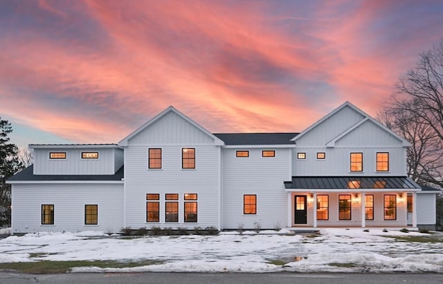 13 Alden Rd, Andover, MA 01810 - snow covered house featuring board and batten siding, covered porch, a standing seam roof, and metal roof