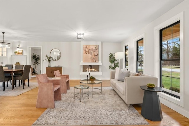 13 Alden Rd, Andover, MA 01810 - living room featuring light wood-type flooring, an inviting chandelier, and a healthy amount of sunlight