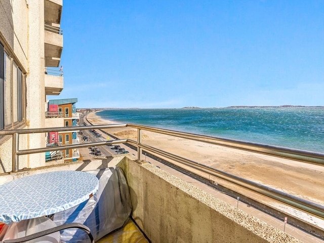 balcony with a beach view and a water view