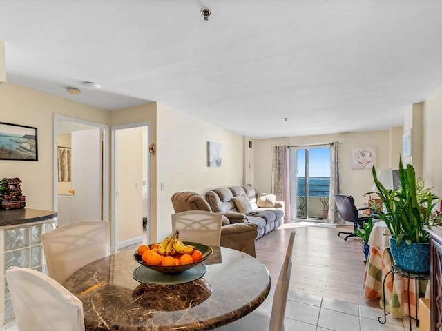 tiled living room featuring a water view