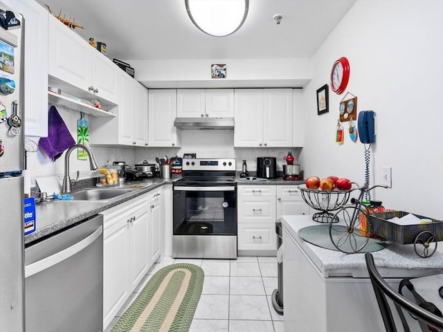 kitchen featuring white cabinetry, stainless steel appliances, sink, and light tile patterned floors