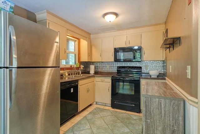 10 Laurel Ln, Bellingham, MA 02019 - kitchen with black appliances, dark countertops, light tile patterned floors, and tasteful backsplash