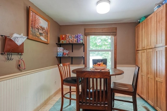 10 Laurel Ln, Bellingham, MA 02019 - dining area with light tile patterned flooring and a wainscoted wall