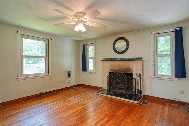 10 Laurel Ln, Bellingham, MA 02019 - unfurnished living room with hardwood / wood-style floors, ceiling fan, and a tiled fireplace