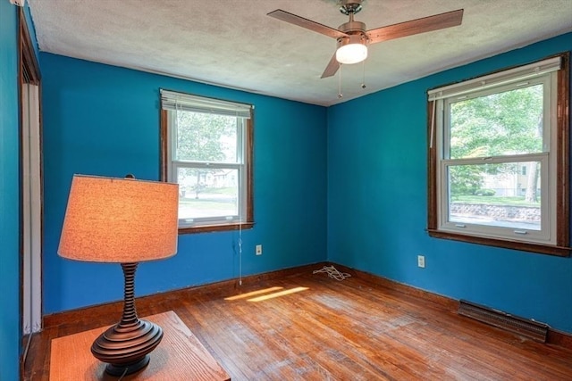 10 Laurel Ln, Bellingham, MA 02019 - spare room with wood finished floors, a textured ceiling, and a ceiling fan