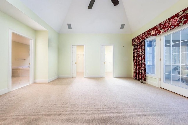 spare room featuring baseboards, light carpet, high vaulted ceiling, and visible vents