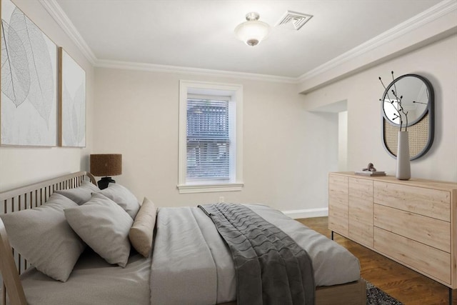 bedroom featuring dark hardwood / wood-style flooring and crown molding