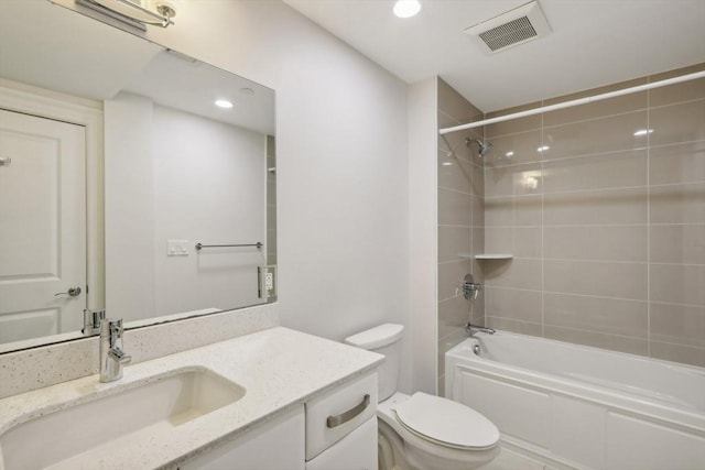 full bathroom with vanity, toilet, and tiled shower / bath