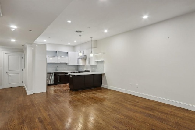 kitchen with backsplash, decorative light fixtures, dark hardwood / wood-style flooring, white cabinetry, and stainless steel appliances