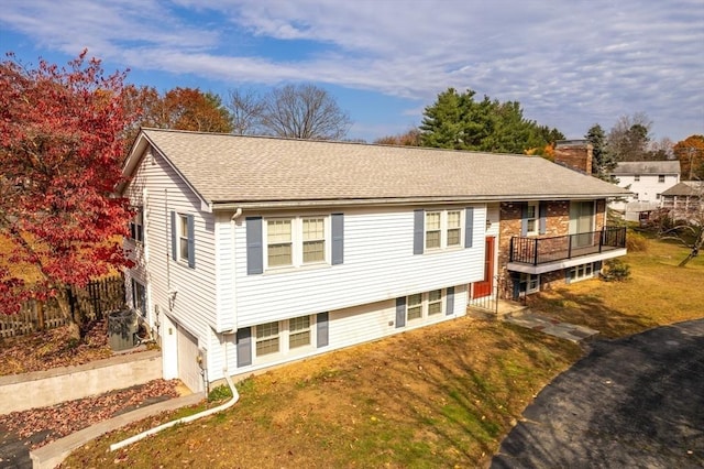 view of front of property with a garage, driveway, roof with shingles, and a chimney