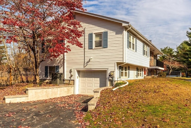 view of home's exterior with an attached garage and driveway