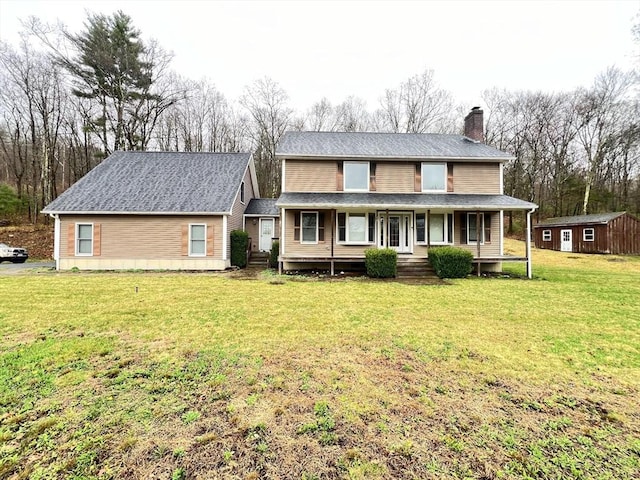 country-style home featuring an outdoor structure, a front lawn, a chimney, and a porch