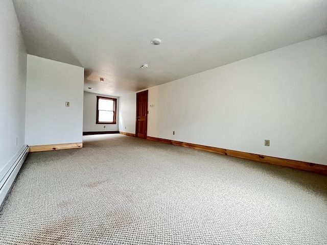 carpeted empty room with baseboards and baseboard heating