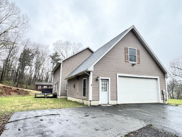 view of side of property with a garage and driveway