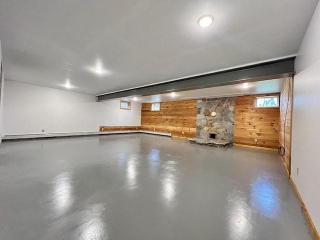 below grade area with baseboards and wood walls