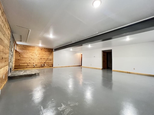 garage featuring wooden walls and baseboards