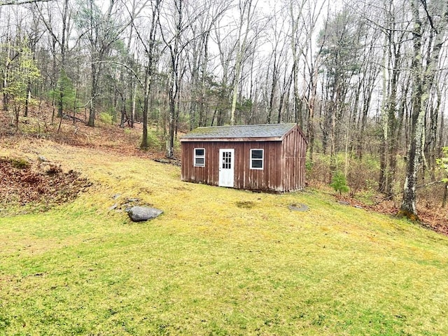 view of shed with a wooded view